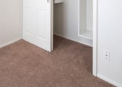 Thumbnail 18 of 30 - a bedroom with a closet and a door that is open