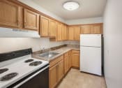 Thumbnail 6 of 30 - a kitchen with wood cabinets and white appliances