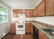 Thumbnail 8 of 30 - a kitchen with wood cabinets and white appliances