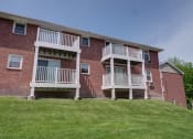 Thumbnail 28 of 38 - a brick apartment building with two sets of balconies