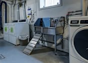 Thumbnail 35 of 38 - A large industrial washing machine is in the foreground of the image.