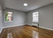 Thumbnail 17 of 25 - A room with wooden floors and a window.