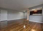 Thumbnail 13 of 25 - A room with wooden floors and a white door.