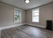 Thumbnail 19 of 27 - A room with a grey floor and a window.