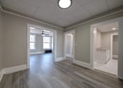 Thumbnail 12 of 27 - Unfurnished room with grey wooden floor at Willett Apartments, Albany, New York