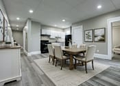Thumbnail 7 of 27 - A dining room with a table set for four.