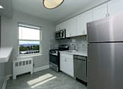 Thumbnail 9 of 25 - A kitchen with a window overlooking a body of water.