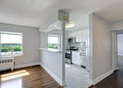 Thumbnail 10 of 25 - A kitchen with white cabinets and a window overlooking a green landscape.