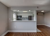 Thumbnail 8 of 25 - A kitchen area with a microwave, oven, and refrigerator.