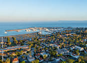 Thumbnail 1 of 30 - A coastal town with a pier and a body of water.