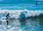 Thumbnail 27 of 30 - A surfer rides a wave in the ocean.