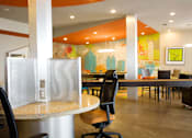 Thumbnail 4 of 17 - a dining area with tables and chairs and a mural on the wall