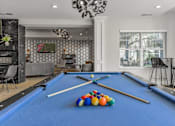 Thumbnail 4 of 5 - a game room with a pool table and billiard balls