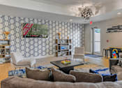 Thumbnail 8 of 16 - a living room with couches and chairs and a tv