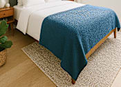 Thumbnail 12 of 14 - A bed with a blue blanket and white pillows is in the image.