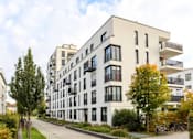Thumbnail 1 of 7 - Outside of Liz Luxury Apartments walking path with greenery