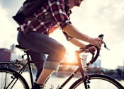 Thumbnail 11 of 17 - guy riding bike in city