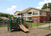 Thumbnail 13 of 17 - a playground with a slide in front of an apartment building