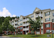 Thumbnail 12 of 17 - an exterior view of an apartment building on a sunny day