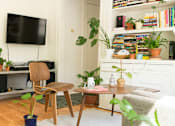 Thumbnail 2 of 12 - a living room filled with furniture and a flat screen tv