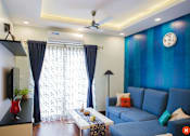 Thumbnail 1 of 4 - a living room with blue walls and a blue couch
