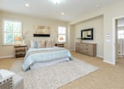Thumbnail 5 of 5 - A bedroom with a large bed, a dresser, and a painting on the wall.