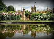 Thumbnail 8 of 9 - a large castle with a pond in front of it