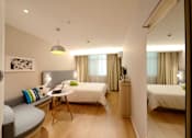 Thumbnail 4 of 4 - a hotel room with two beds and a desk and a mirror