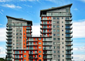 Thumbnail 2 of 5 - Two modern buildings with balconies and glass windows.