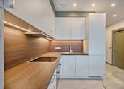 Thumbnail 2 of 5 - a kitchen with wooden countertops and white cabinets