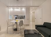 Thumbnail 4 of 5 - a small dining area next to the kitchen in a 555 waverly unit