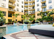 Thumbnail 6 of 17 - a large swimming pool in front of an apartment building