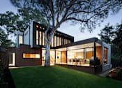 Thumbnail 3 of 6 - a large modern house with a large tree in the yard
