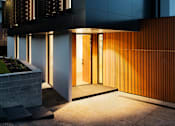 Thumbnail 2 of 6 - the front facade of a modern house with a front door