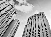 Thumbnail 1 of 5 - a black and white photo of two tall buildings