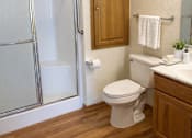 Thumbnail 15 of 38 - A white toilet sits next to a sink in a bathroom.
