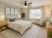 Thumbnail 15 of 41 - A bedroom with a large bed, a chair, and a ceiling fan.