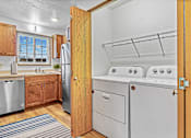 Thumbnail 3 of 12 - A kitchen with a refrigerator, dishwasher, and oven.
