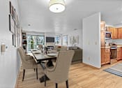 Thumbnail 5 of 12 - A modern dining room with a table set for four.