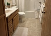 Thumbnail 17 of 41 - A bathroom with a toilet, sink, and shower.