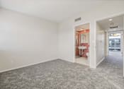 Thumbnail 23 of 47 - A room with a carpeted floor and a bathroom visible through an open door.