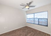 Thumbnail 41 of 47 - A room with a ceiling fan and a window with blinds.