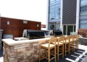Thumbnail 17 of 18 - Community BBQ area with seating and counter
