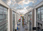 Thumbnail 45 of 47 - A long corridor with a red awning at the end.
