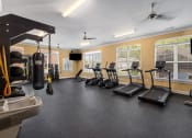 Thumbnail 11 of 18 - an exercise room with treadmills and other fitness equipment