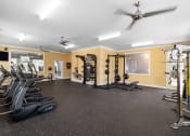 Thumbnail 12 of 18 - a spacious fitness room with carpeted flooring and a large window with a view of the