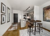 Thumbnail 3 of 18 - a kitchen with white walls and a wooden floor