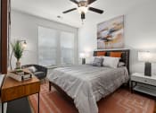 Thumbnail 6 of 18 - a bedroom with a bed and a ceiling fan