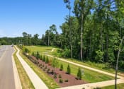 Thumbnail 16 of 18 - a view of a road and a park with trees