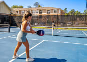 Thumbnail 14 of 18 - a woman holding a tennis racquet on a tennis court